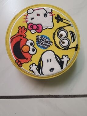 Like new "Universal Studios, Japan" yellow character patch trinket box, round